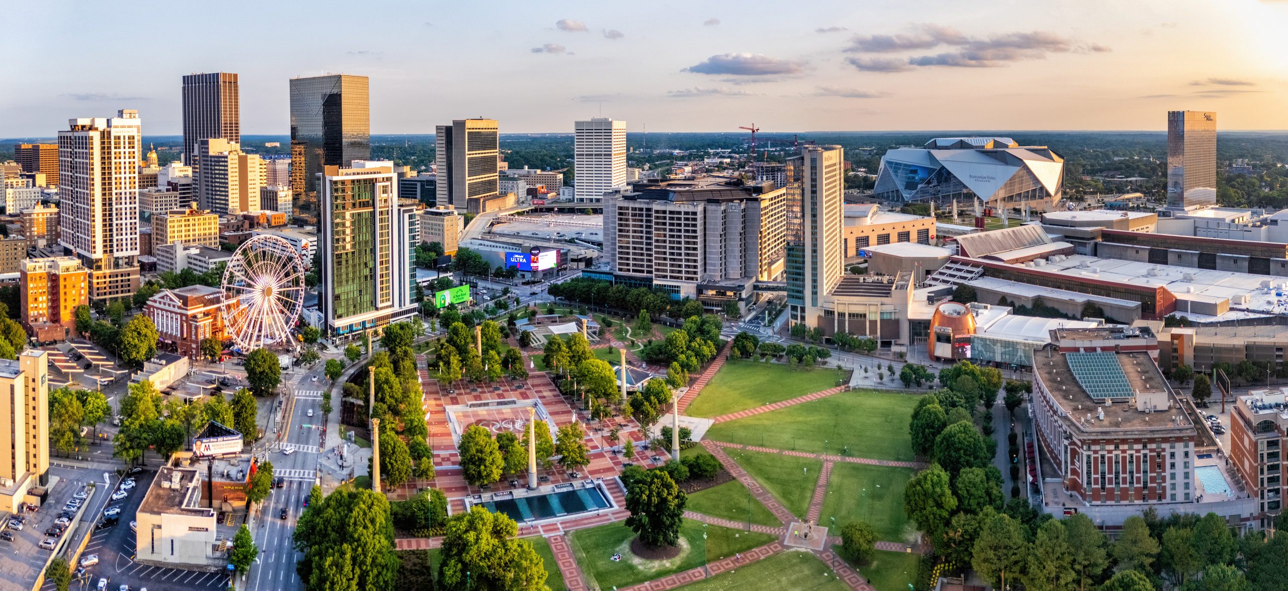 AtlantaDowntownCentennialParkAerial2024 Aerial shot of Centennial Olympic Park featuring Skyview Atlanta, CNN Center, the College Football Hall of Fame, GWCC, and Mercedes-Benz Stadium.